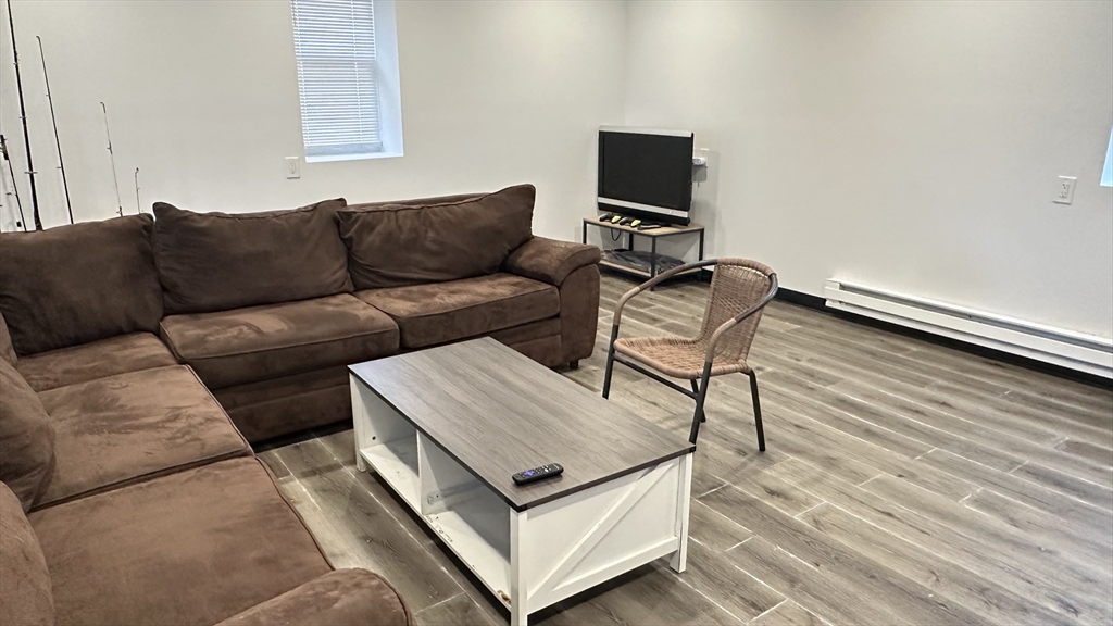 46-48 Buckley Street Quincy, MA 02169 - Photo 7 of 42 a living room with furniture and a wooden floor