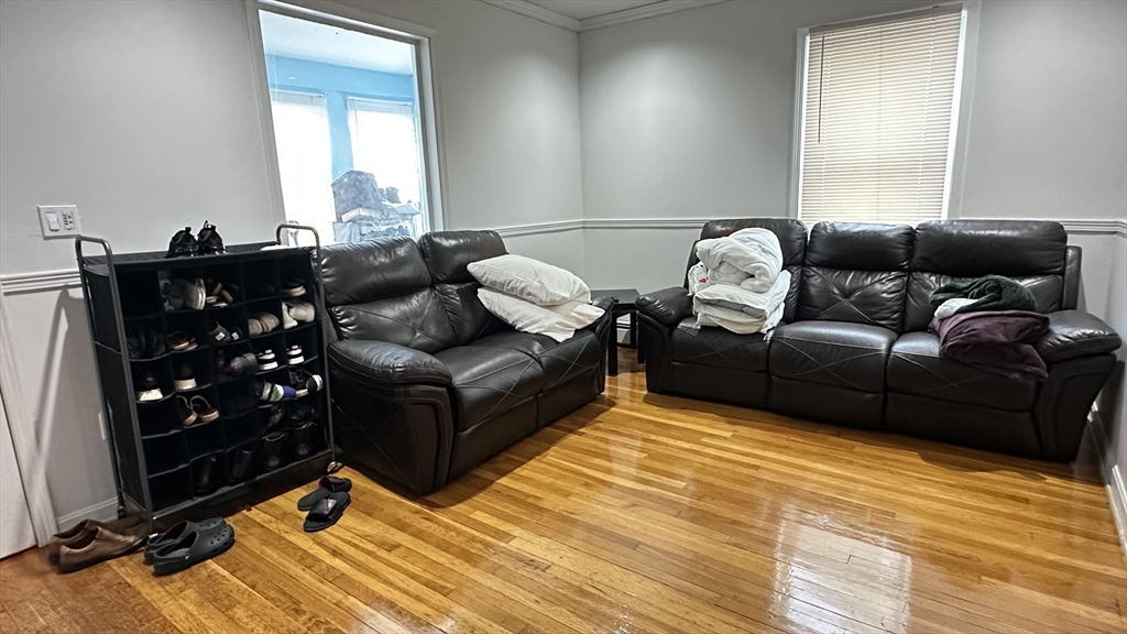 46-48 Buckley Street Quincy, MA 02169 - Photo 8 of 42 a living room with furniture window and a wooden floor