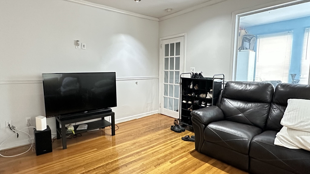 46-48 Buckley Street Quincy, MA 02169 - Photo 9 of 42 a living room with furniture and a flat screen tv