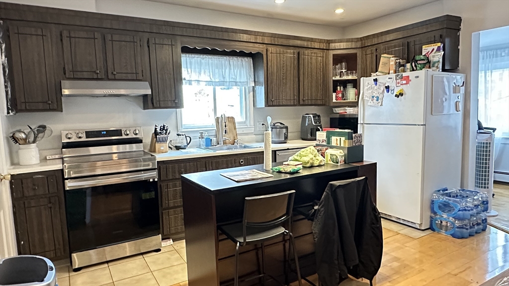 46-48 Buckley Street Quincy, MA 02169 - Photo 10 of 42 a kitchen with refrigerator and cabinets