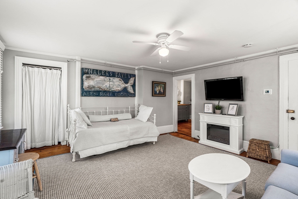 45 Washington Street, Unit 3 Marblehead, MA 01945 - Photo 12 of 24 a living room with fireplace furniture and a flat screen tv