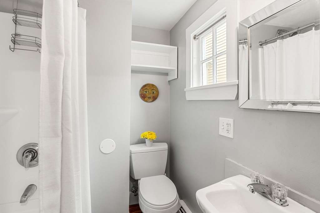 45 Washington Street, Unit 3 Marblehead, MA 01945 - Photo 21 of 24 a bathroom with a sink a toilet and a mirror