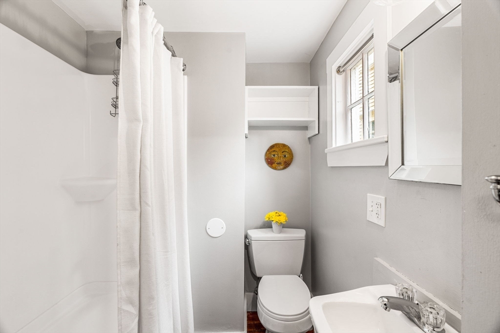 45 Washington Street, Unit 3 Marblehead, MA 01945 - Photo 22 of 24 a bathroom with a toilet sink and mirror