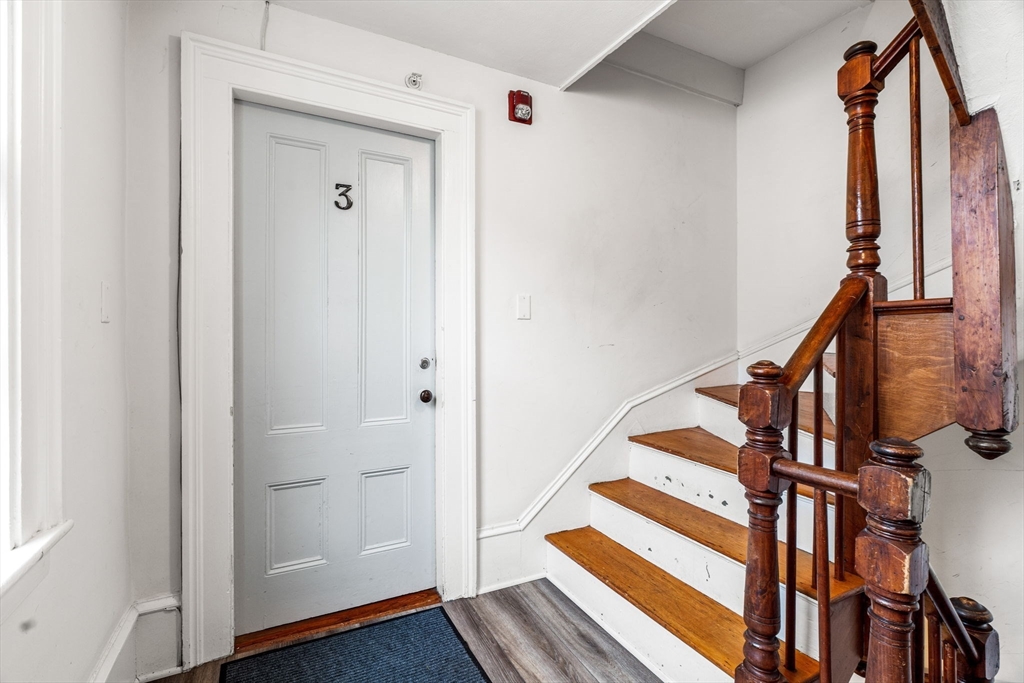 45 Washington Street, Unit 3 Marblehead, MA 01945 - Photo 5 of 24 a view of front door with wooden floor and stairs