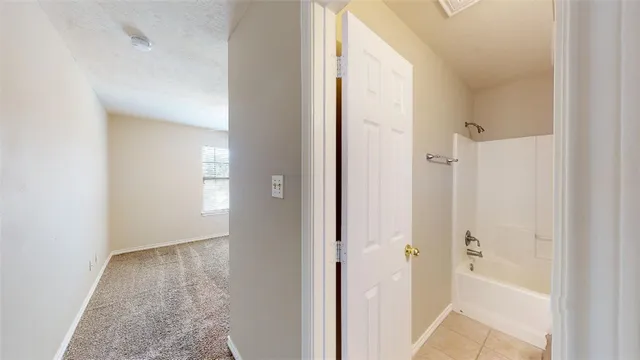 a view of a bathroom from a hallway