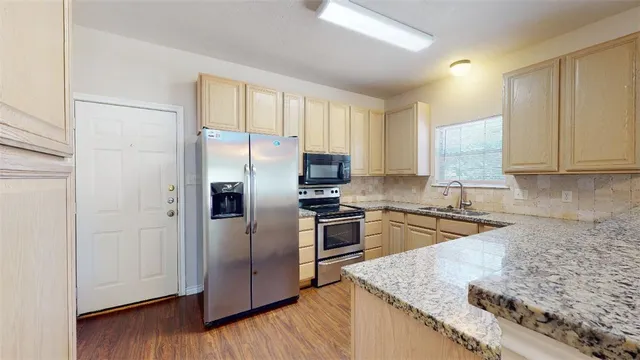 a kitchen with a refrigerator stove and sink