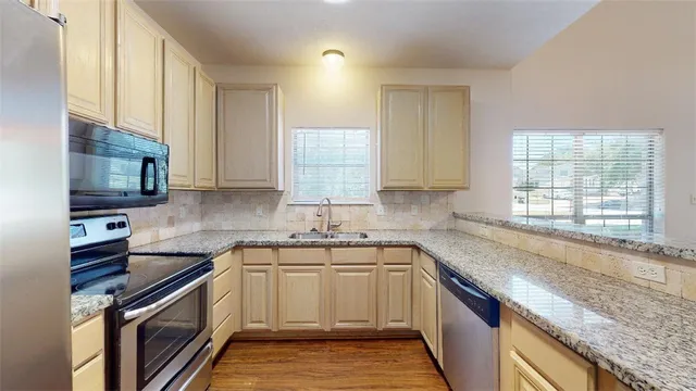 a kitchen with a sink stove top oven and microwave
