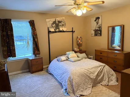 a bedroom with a bed and a dresser
