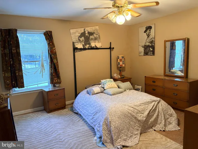 a bedroom with a bed and a dresser