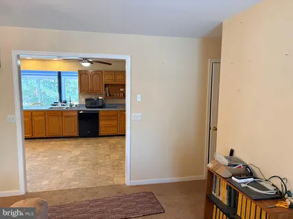 a view of kitchen with stove and cabinets