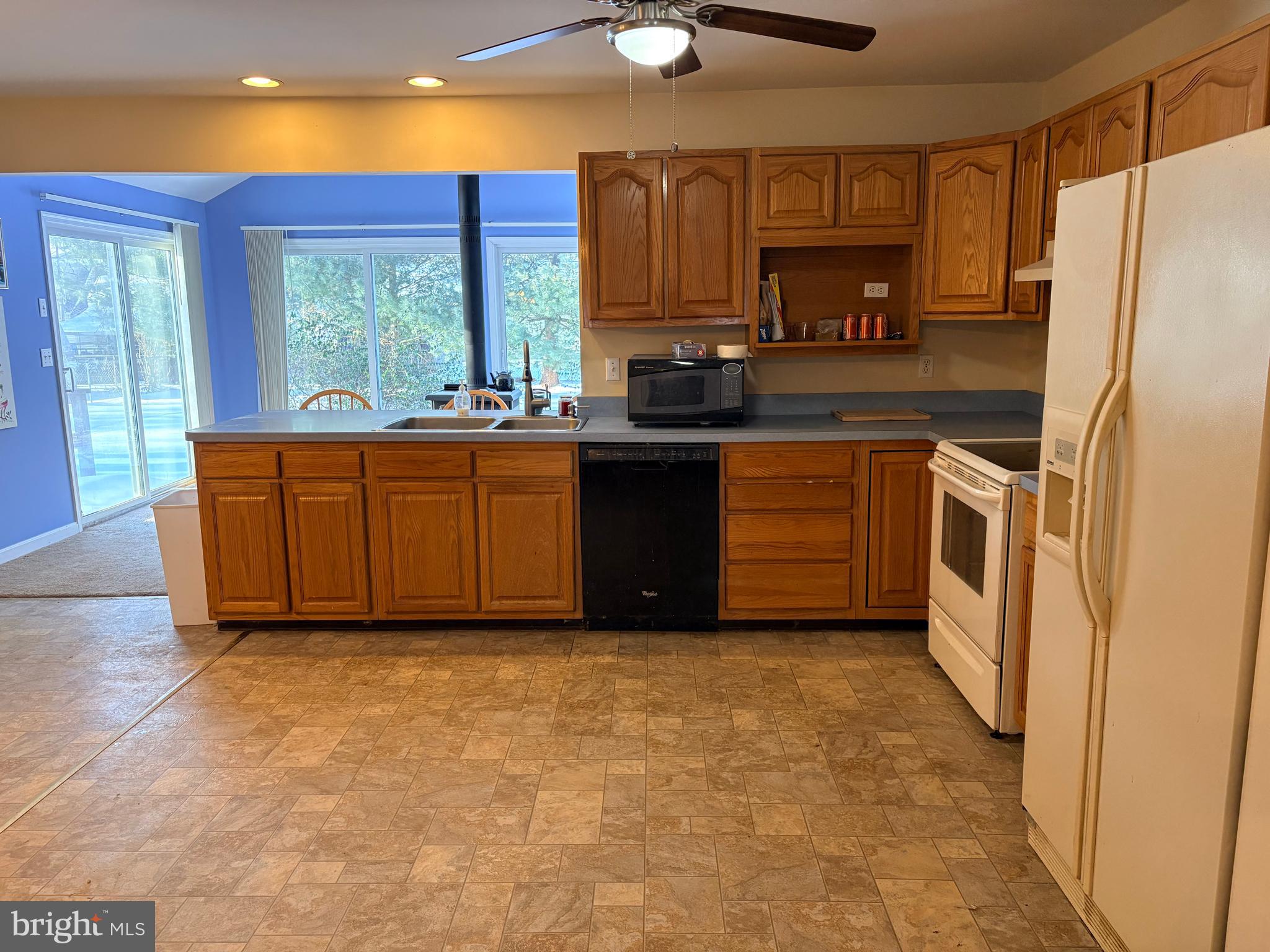 119 Darden Road Chestertown, MD 21620 - Photo 4 of 19 a kitchen with granite countertop a refrigerator a sink a stove a microwave and island
