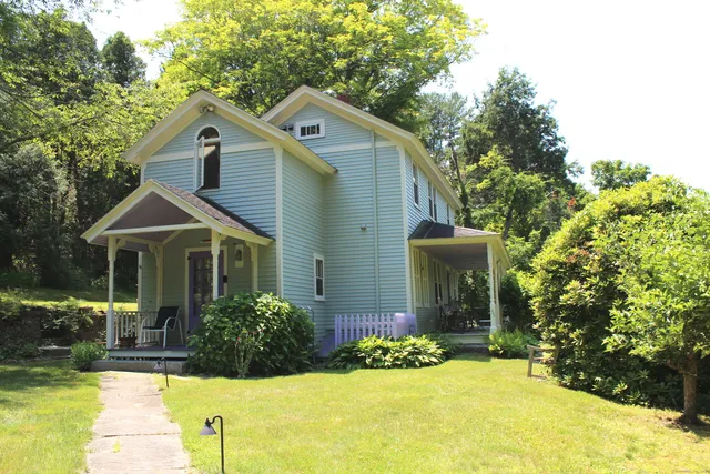 a front view of a house with a yard
