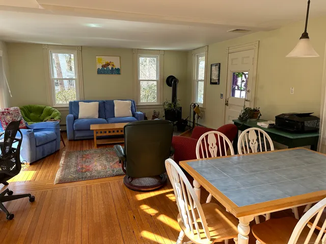 a living room with furniture a rug and a window