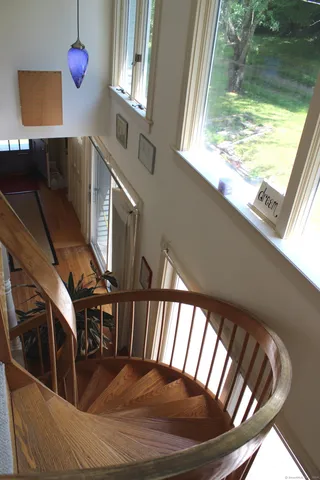 a view of entryway and hall with wooden floor