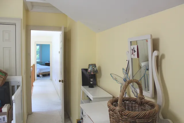a view of a hallway view with wooden floor and staircase