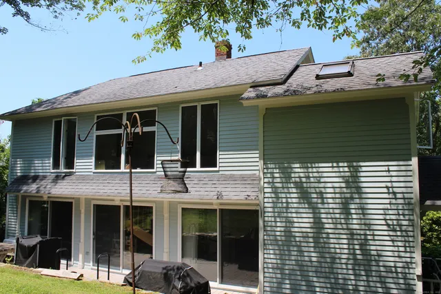 a view of a house with a large window and balcony