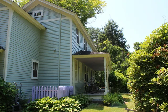 a view of a small house with potted plants