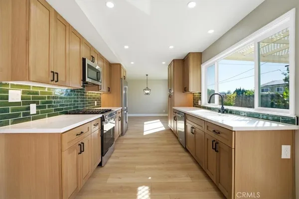 a view of an empty room with wooden floor and a yard
