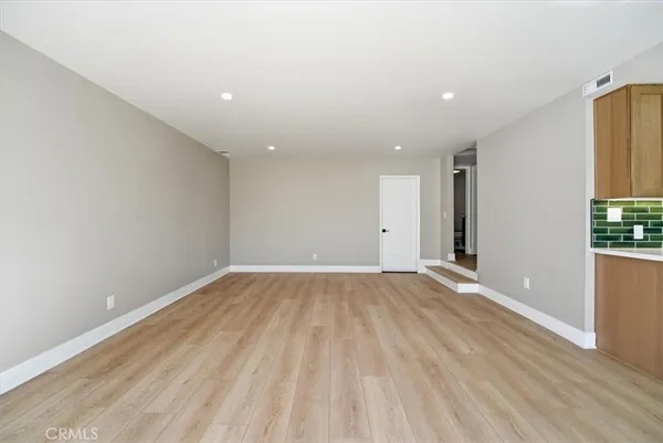 a bathroom with a granite countertop sink mirror vanity and toilet