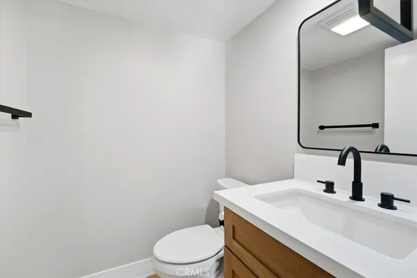 an empty room with wooden floor and window