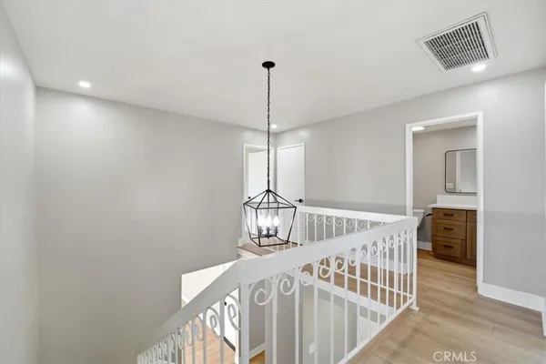 an empty room with wooden floor and a window