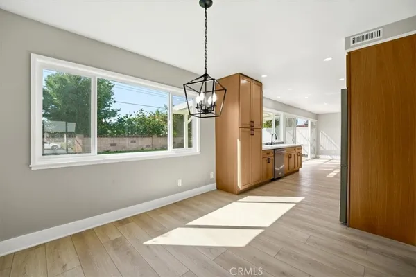 a area with wooden floor and windows