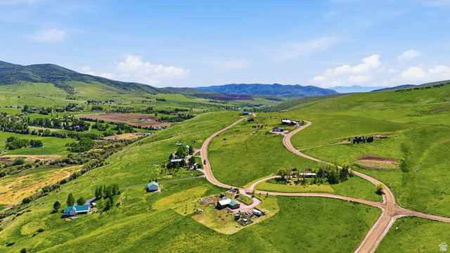 8066 North Valley View Heights Preston, ID 83263 - Photo 31 of 34 Expansive green hillside property featuring multiple residential structures and winding unpaved roads