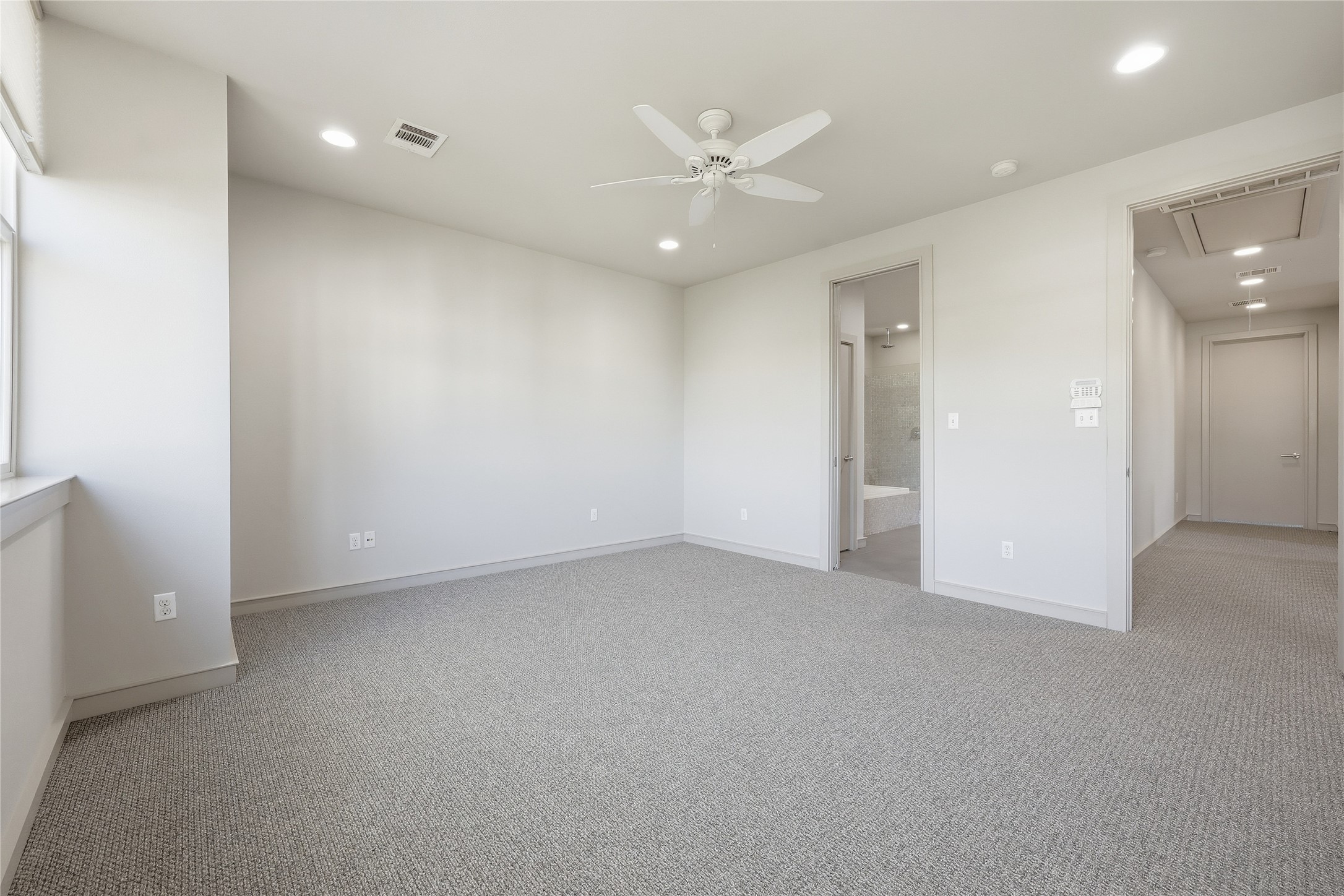3507 Harmon Avenue Austin, TX 78705 - Photo 20 of 36 an empty room with a ceiling fan and a bathroom