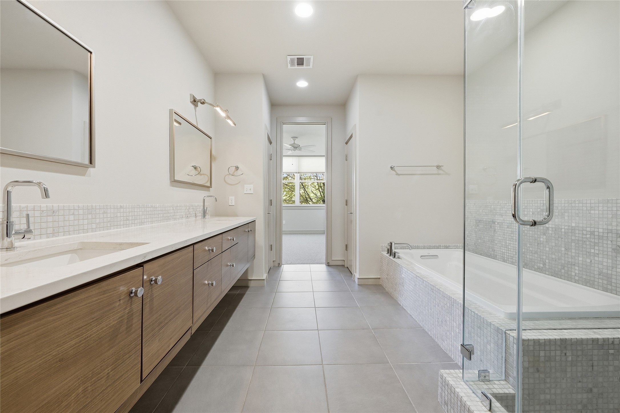 3507 Harmon Avenue Austin, TX 78705 - Photo 22 of 36 a large white bathroom with a granite countertop sink a toilet a mirror and shower