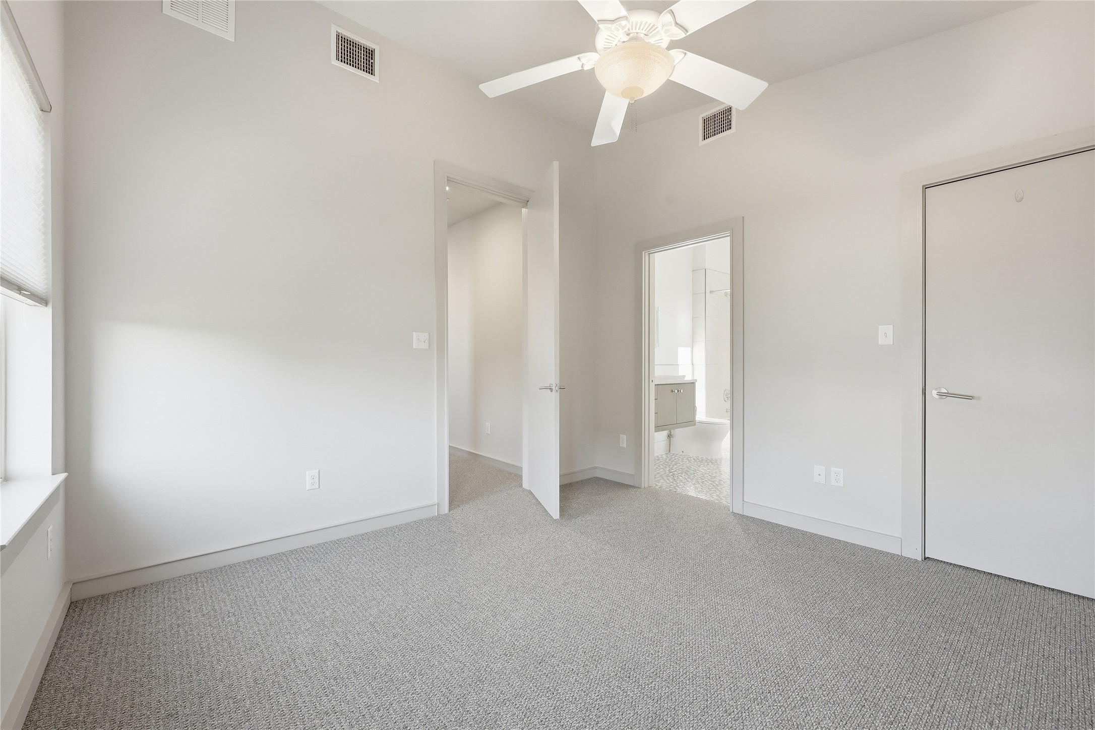 3507 Harmon Avenue Austin, TX 78705 - Photo 26 of 36 an empty room with a ceiling fan and a window