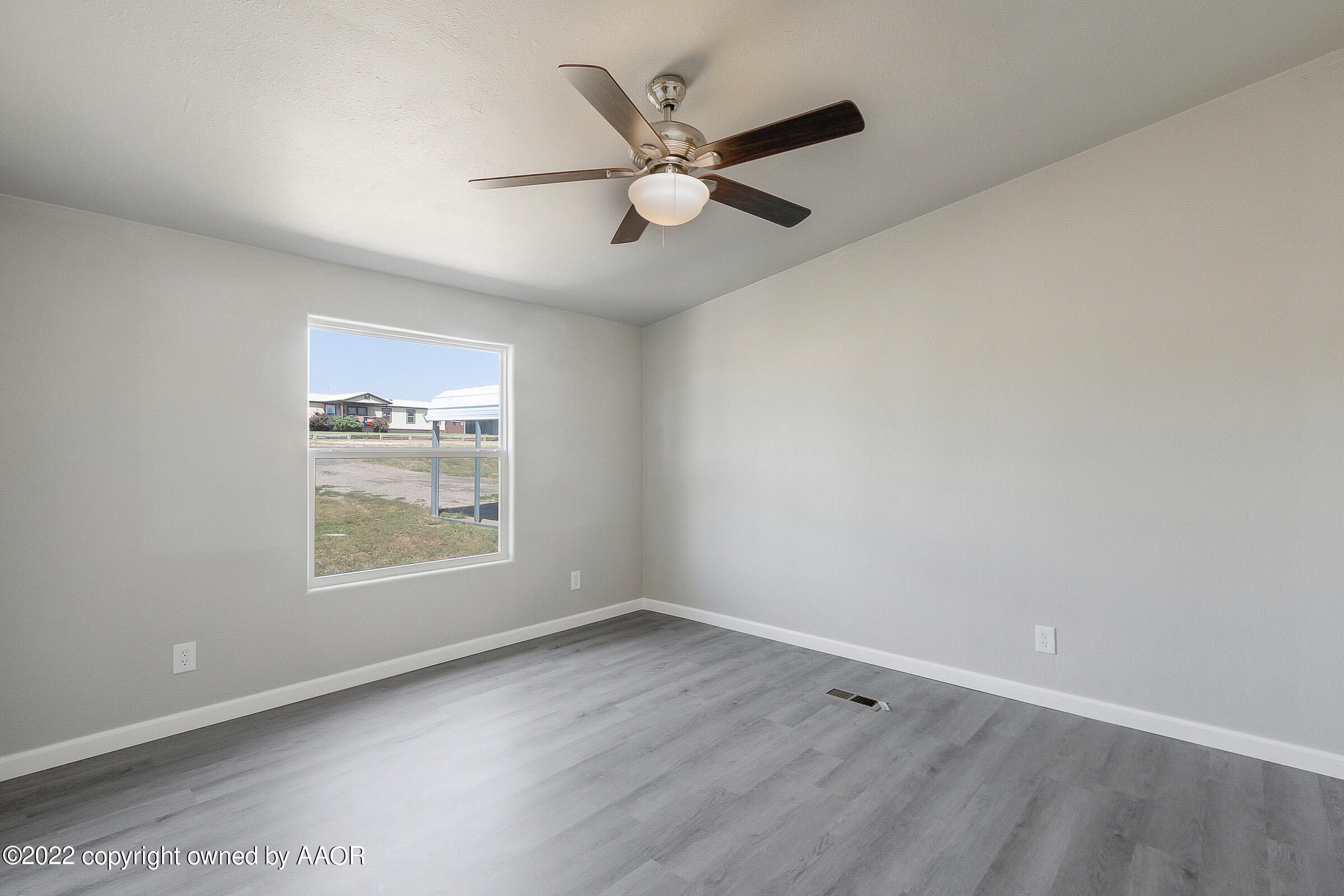 3501 Silver Hill Circle Amarillo, TX 79108 - Photo 13 of 25 an empty room with wooden floor and windows