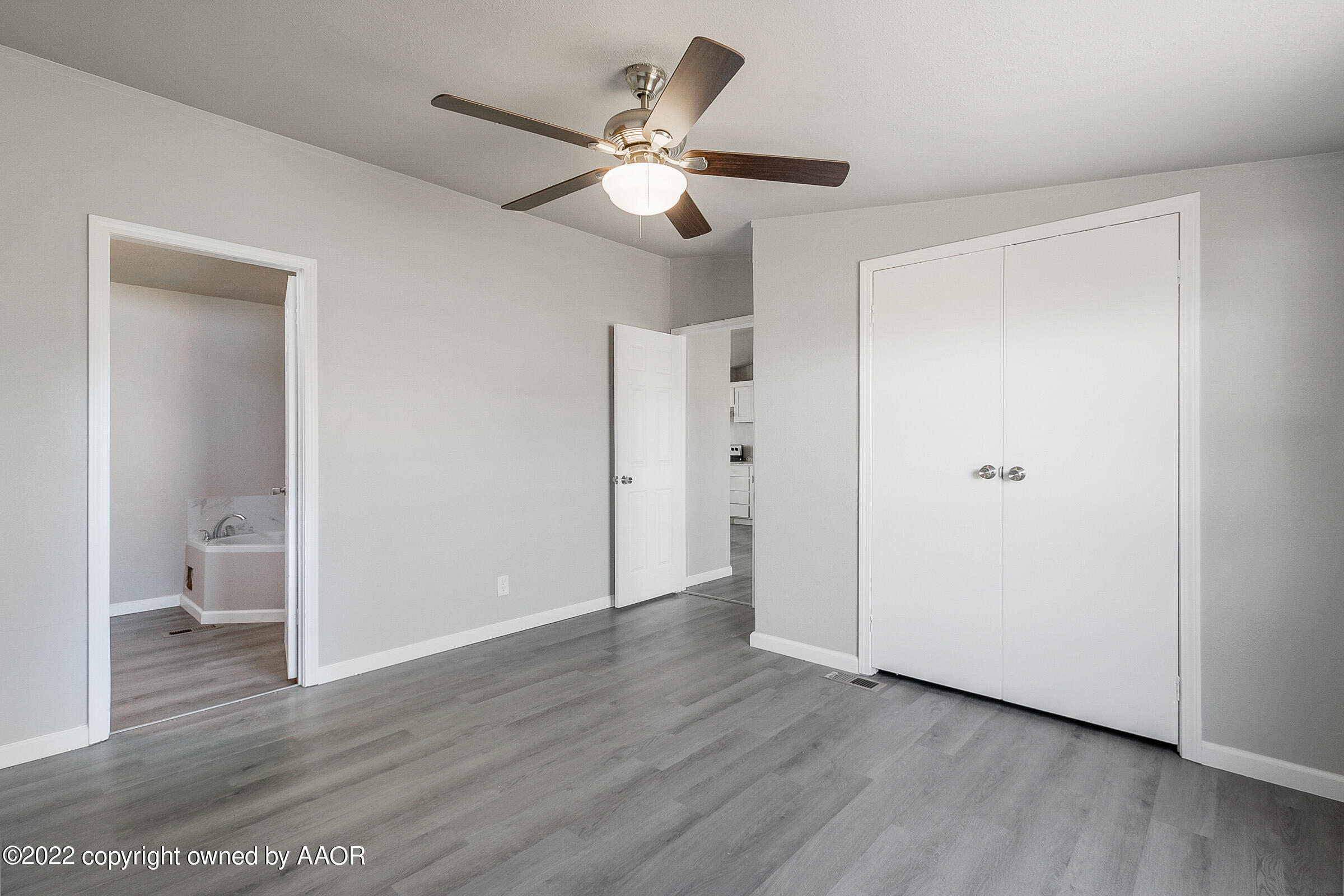 3501 Silver Hill Circle Amarillo, TX 79108 - Photo 14 of 25 a view of a hallway with wooden floor and a ceiling fan