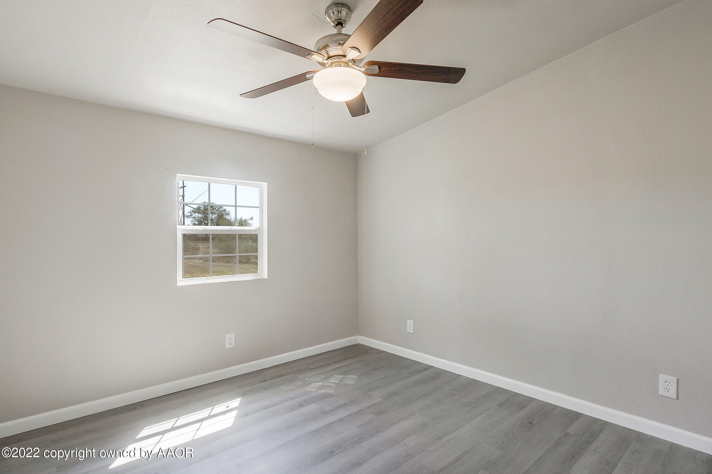 3501 Silver Hill Circle Amarillo, TX 79108 - Photo 17 of 25 an empty room with wooden floor and windows