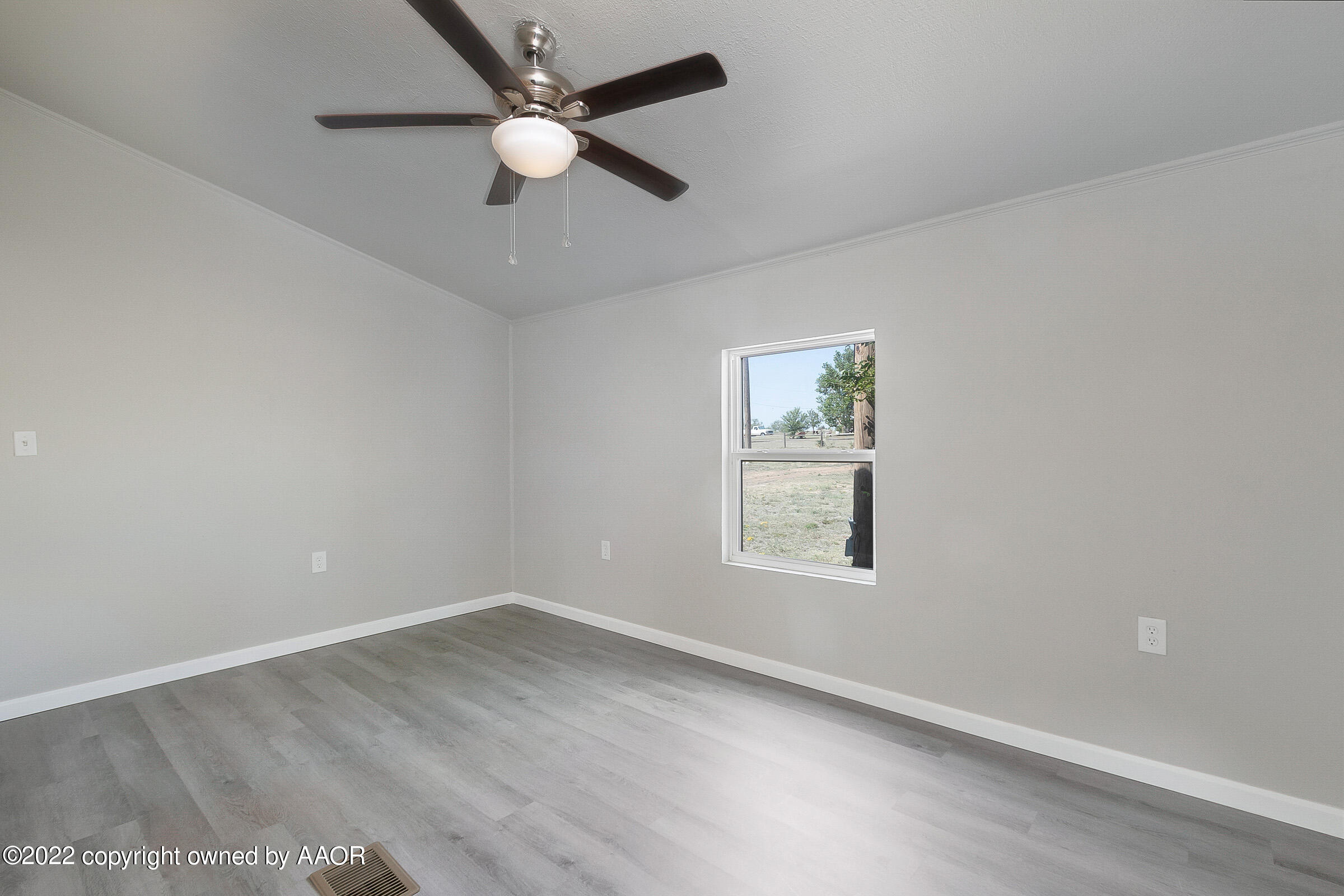 3501 Silver Hill Circle Amarillo, TX 79108 - Photo 18 of 25 an empty room with a window and ceiling fan