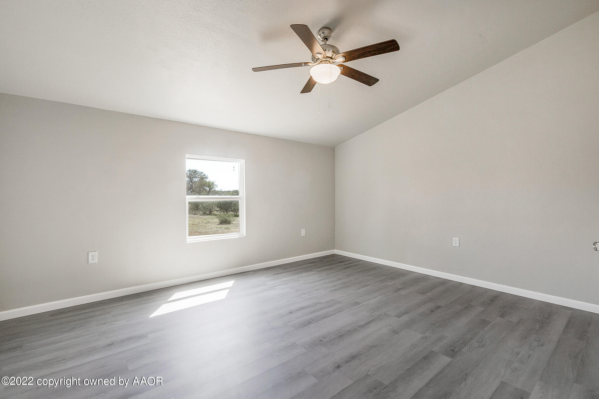 3501 Silver Hill Circle Amarillo, TX 79108 - Photo 20 of 25 an empty room with wooden floor fan and windows