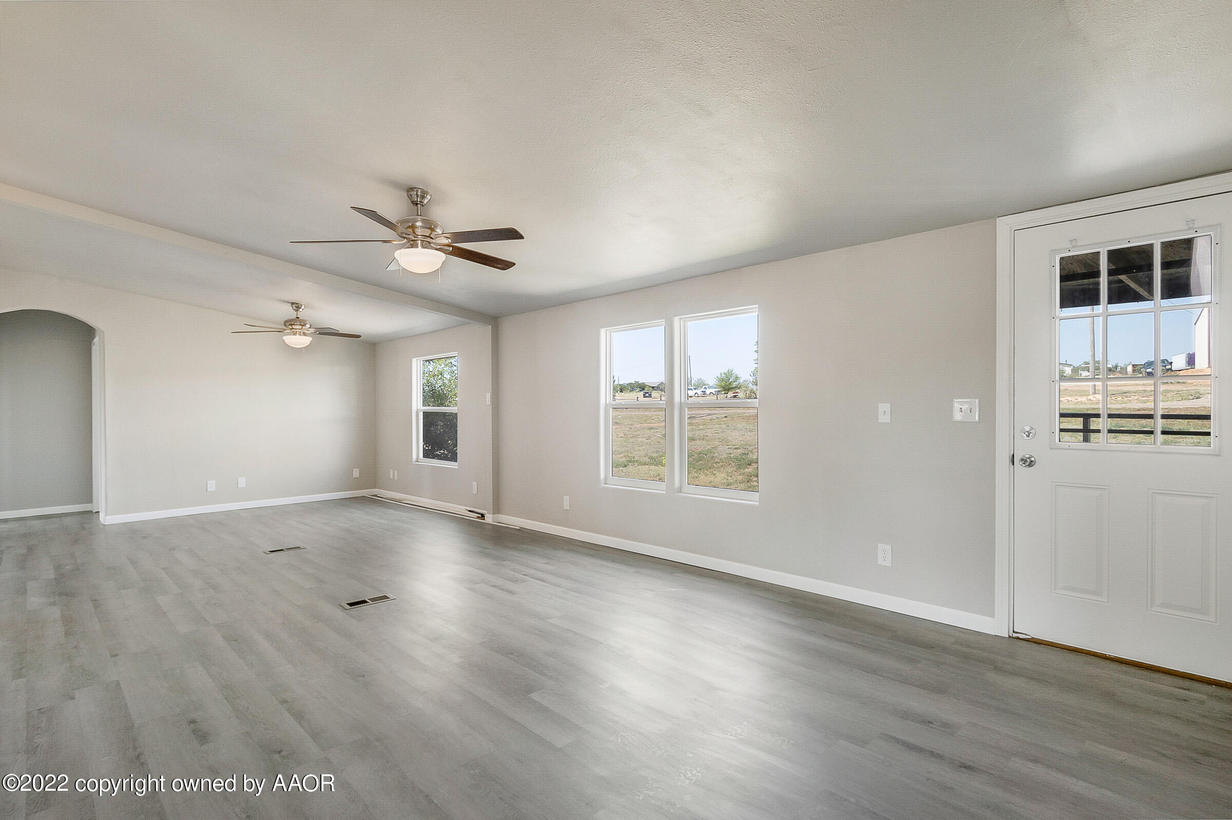 3501 Silver Hill Circle Amarillo, TX 79108 - Photo 6 of 25 a view of an empty room with wooden floor and a window