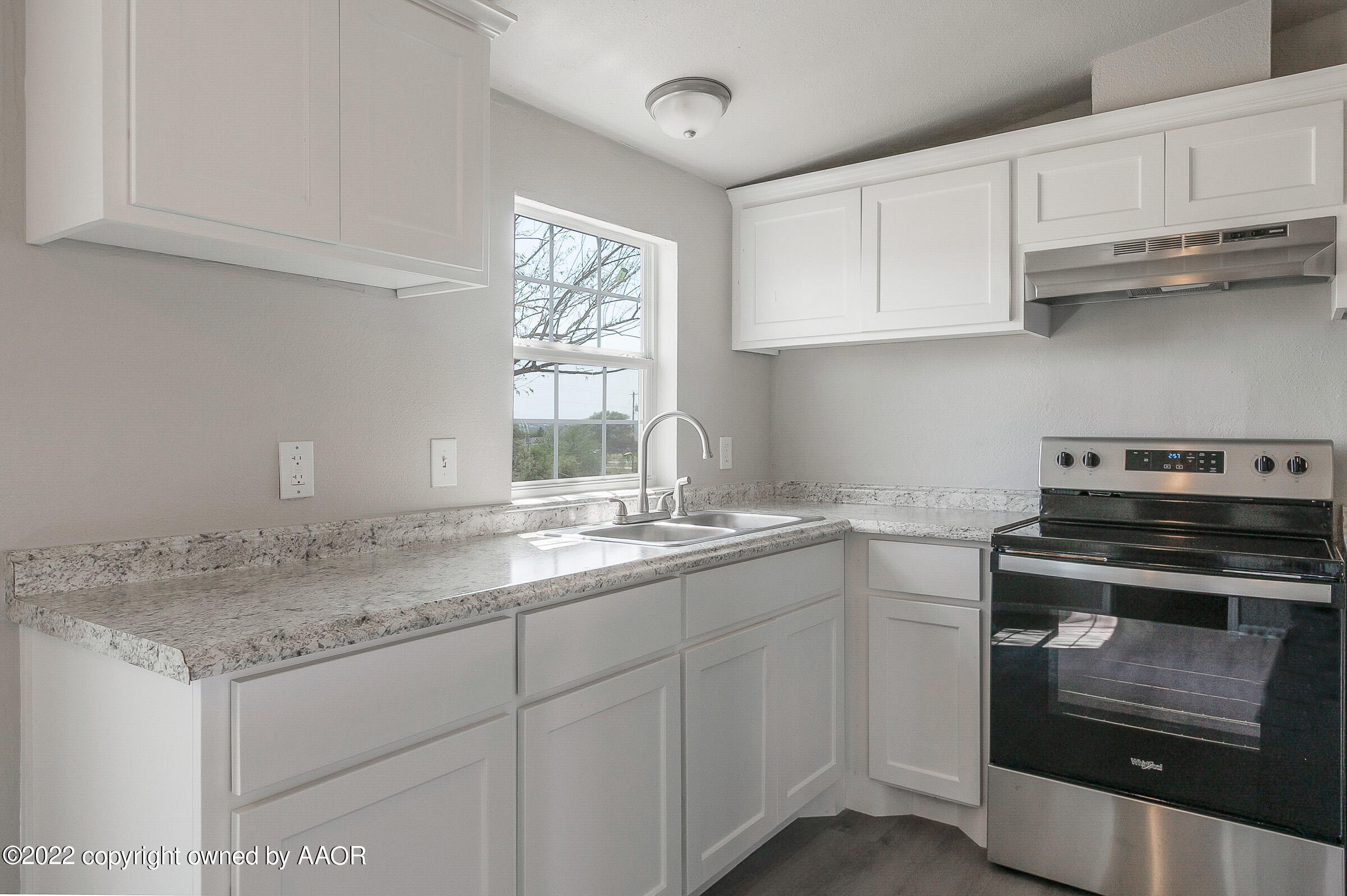 3501 Silver Hill Circle Amarillo, TX 79108 - Photo 10 of 25 a kitchen with white cabinets appliances a sink and a window