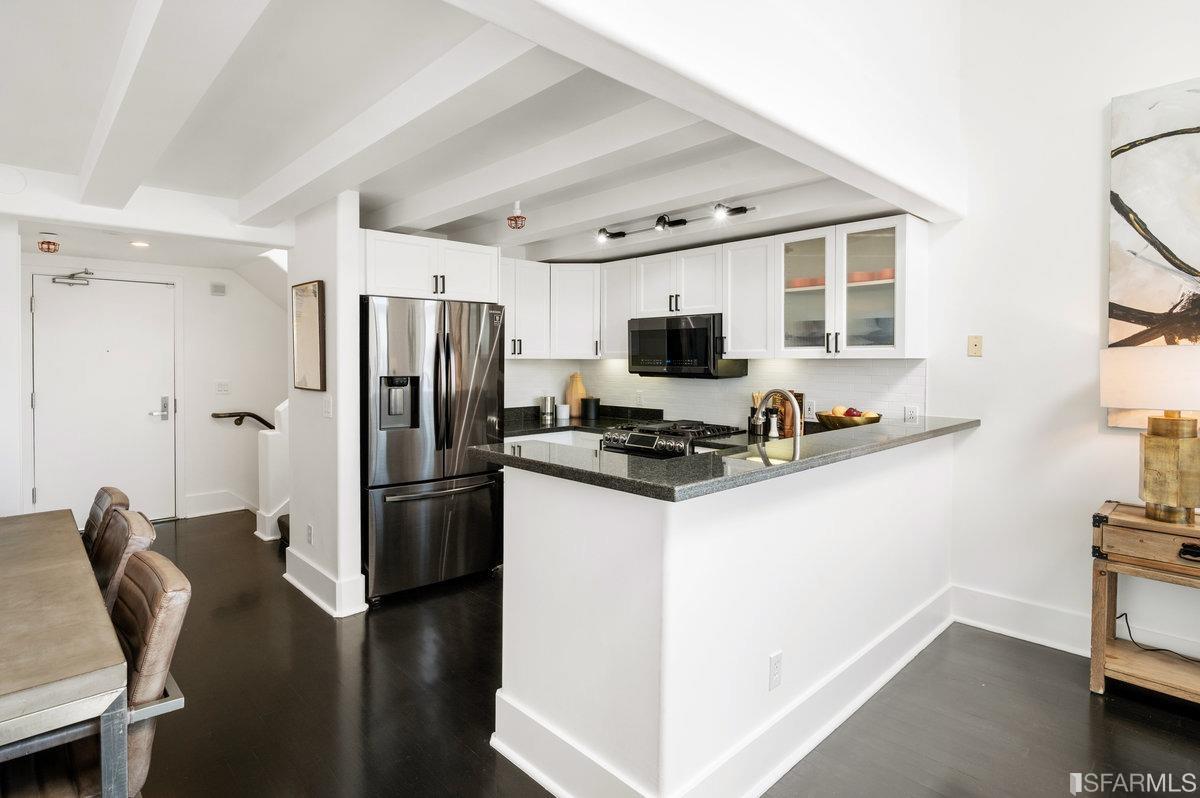 638 Minna, Unit 7 San Francisco, CA 94103 - Photo 21 of 57 a kitchen with stainless steel appliances a refrigerator stove and microwave