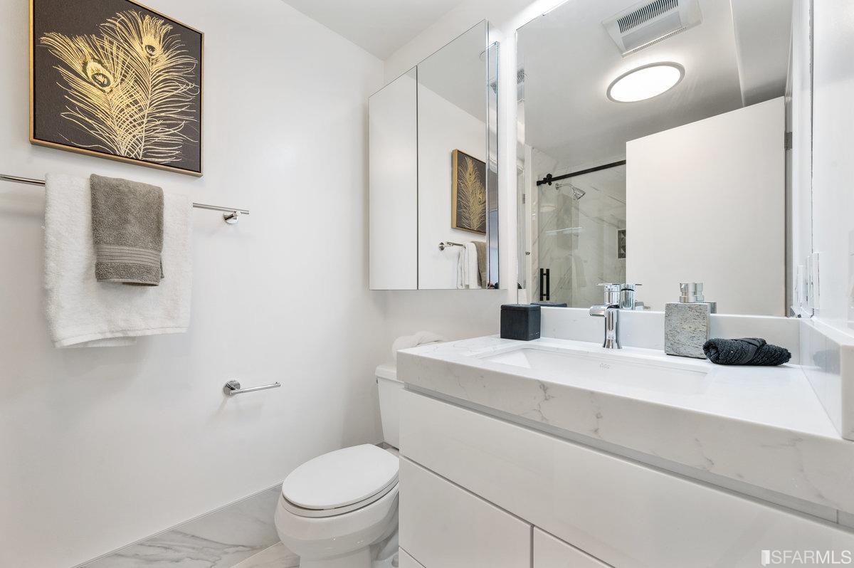 638 Minna, Unit 7 San Francisco, CA 94103 - Photo 49 of 57 a bathroom with a sink a toilet and a mirror