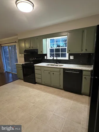 a kitchen with stainless steel appliances granite countertop a stove sink and cabinets