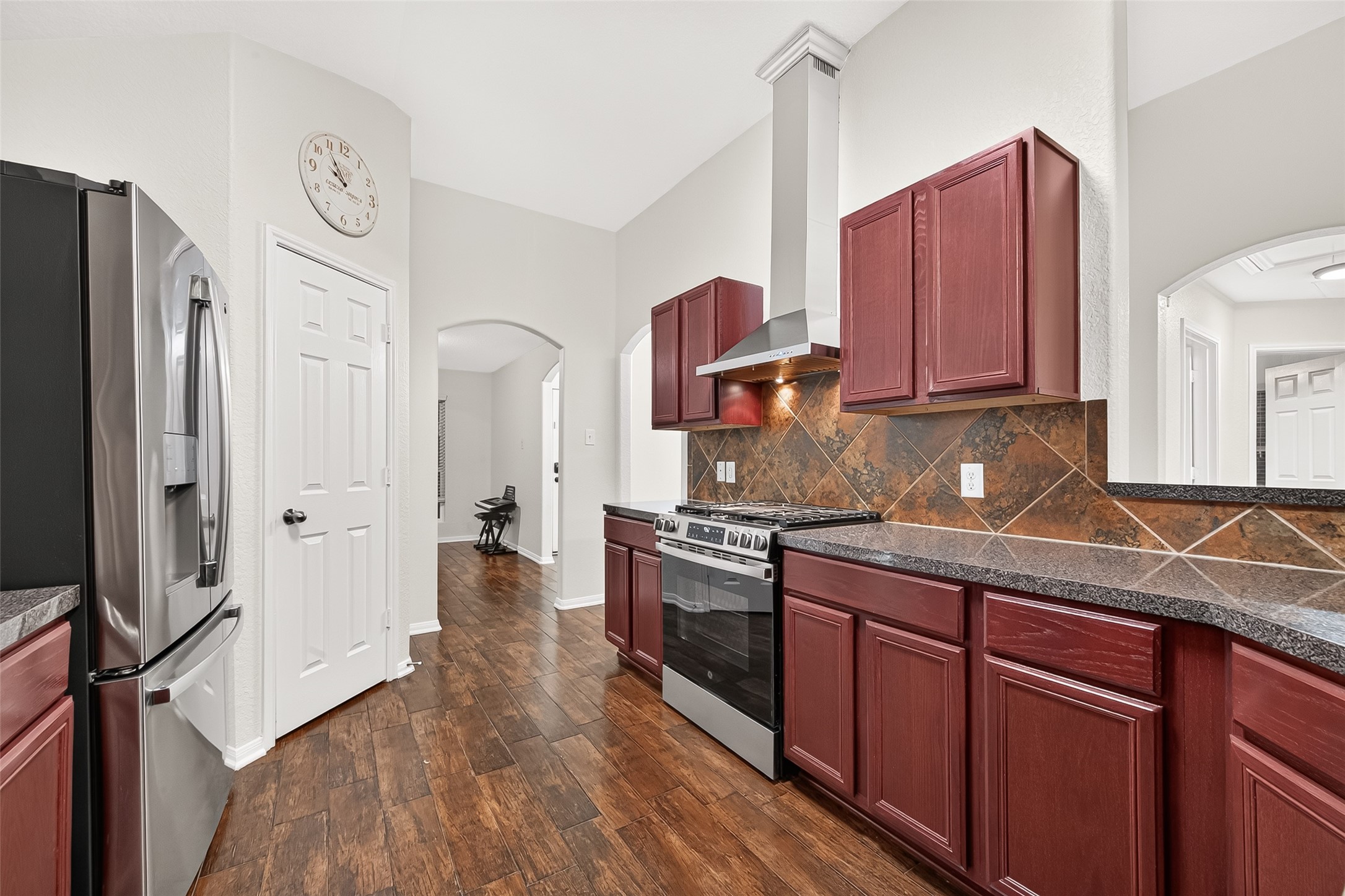 3155 View Valley Trail Katy, TX 77493 - Photo 24 of 50 Alternative angle of the kitchen layout, emphasizing the pristine wood-style flooring and open feel