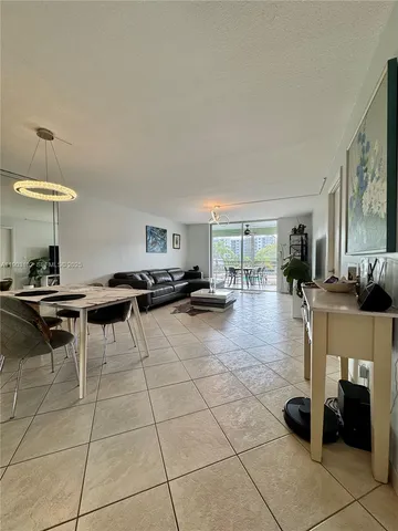 a living room with furniture a clock and a table