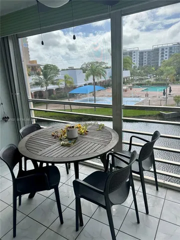 a view of a chairs and table in the balcony