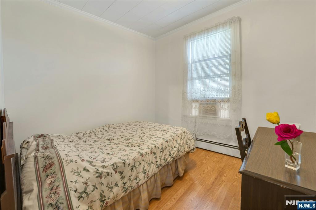 79 Washington Street Harrison, NJ 07029 - Photo 17 of 25 a bedroom with a bed and a window