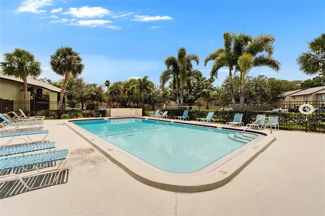 a swimming pool with outdoor seating and yard
