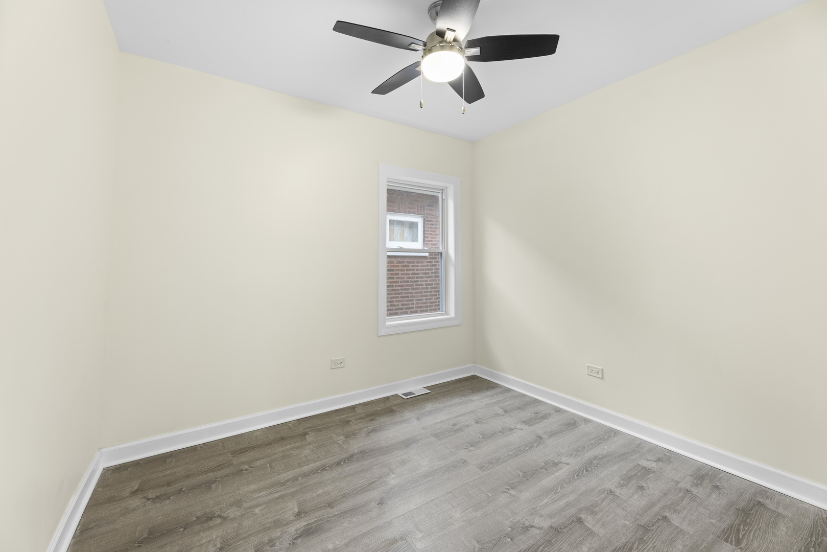 8946 South May Street Chicago, IL 60620 - Photo 13 of 23 an empty room with a window and a ceiling fan