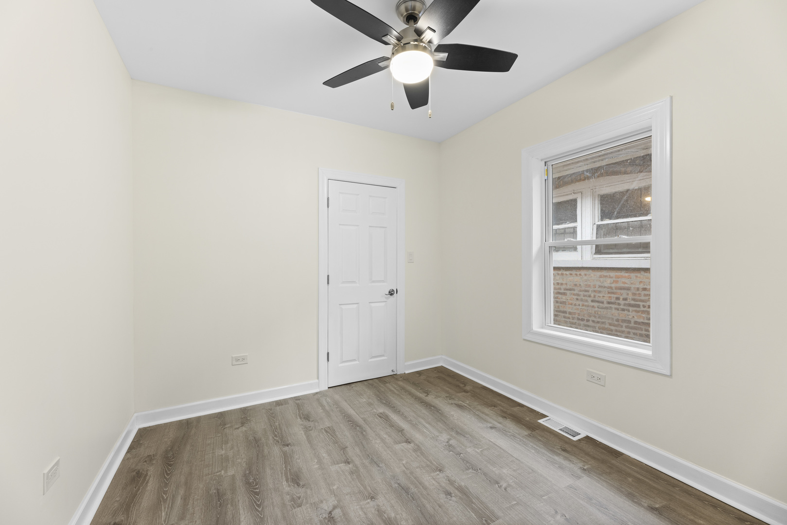 8946 South May Street Chicago, IL 60620 - Photo 15 of 23 an empty room with a window and a ceiling fan