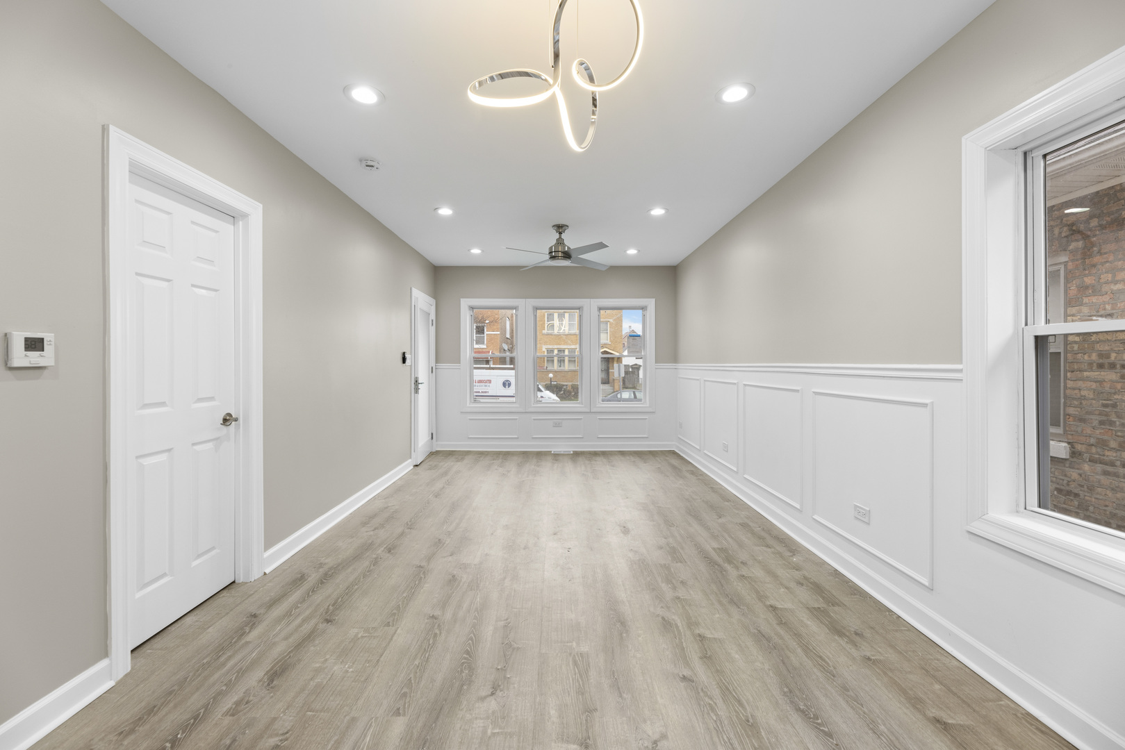 8946 South May Street Chicago, IL 60620 - Photo 18 of 23 an empty room with wooden floor and windows