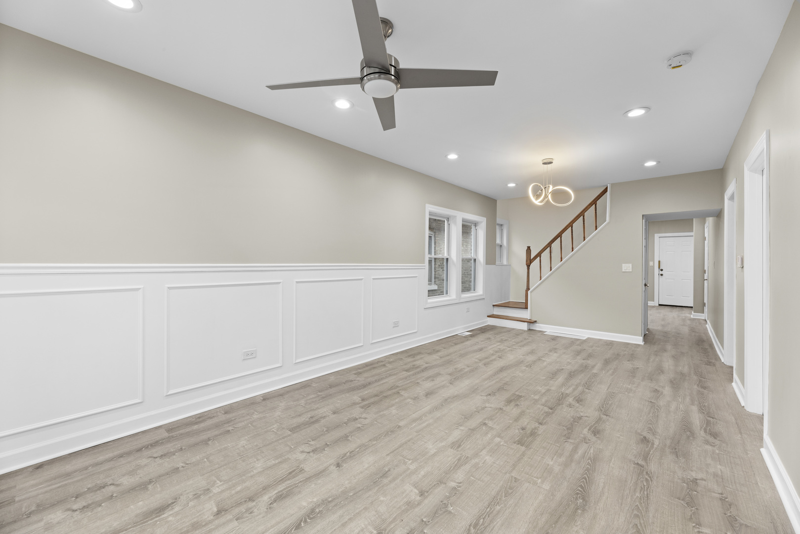 8946 South May Street Chicago, IL 60620 - Photo 19 of 23 an empty room with wooden floor fan and windows