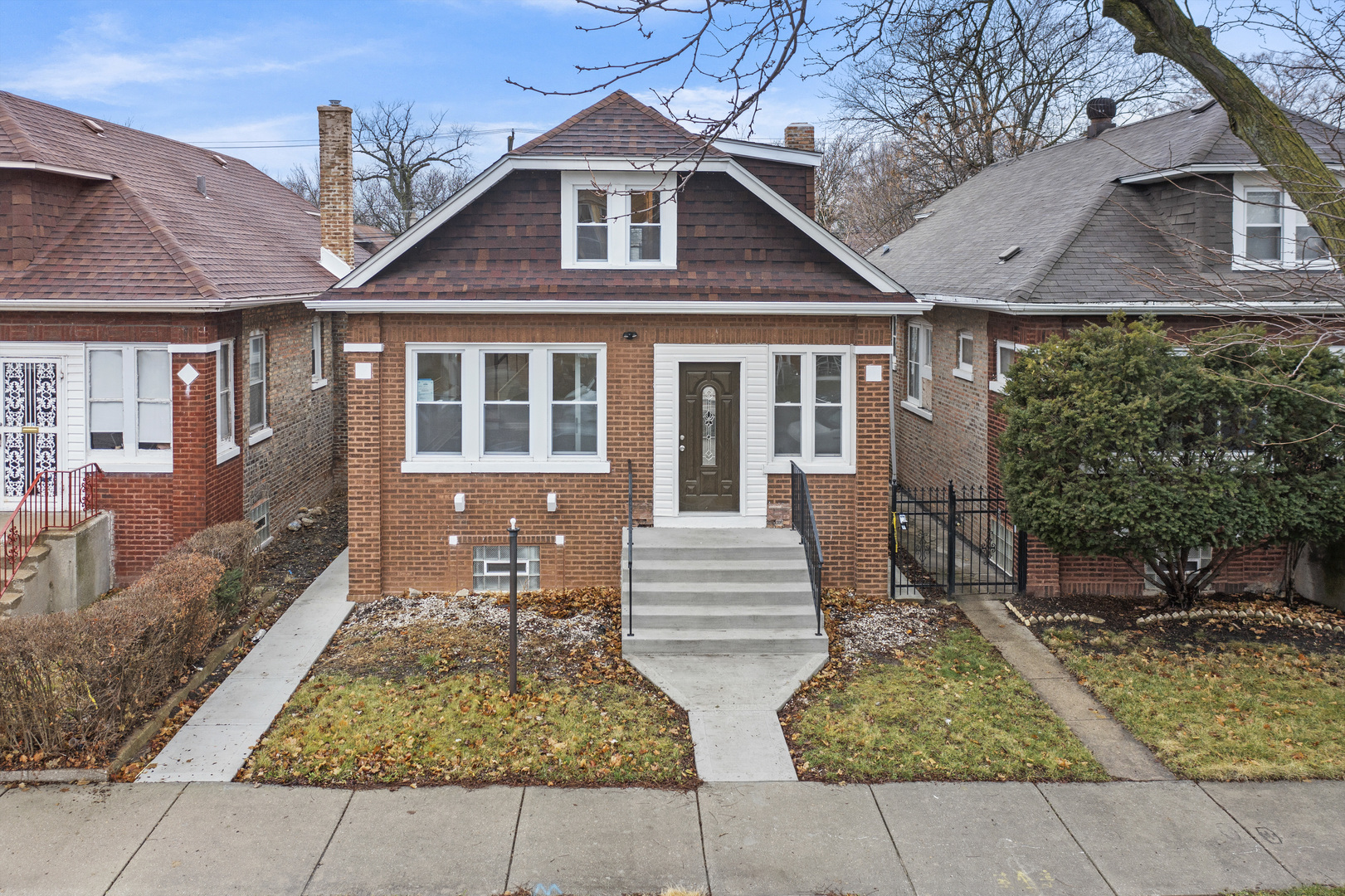 8946 South May Street Chicago, IL 60620 - Photo 2 of 23 a front view of a house with garden